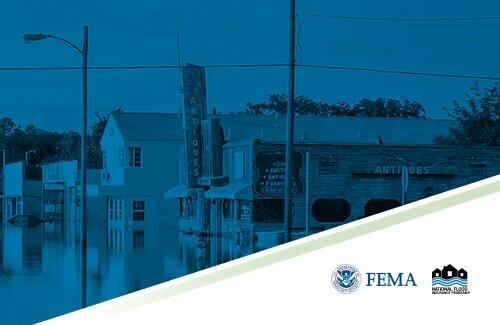 a row of commercial buildings with floodwater up to the lower windows