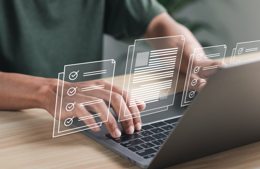 Man typing on laptop, holographic images of documents floating above screen