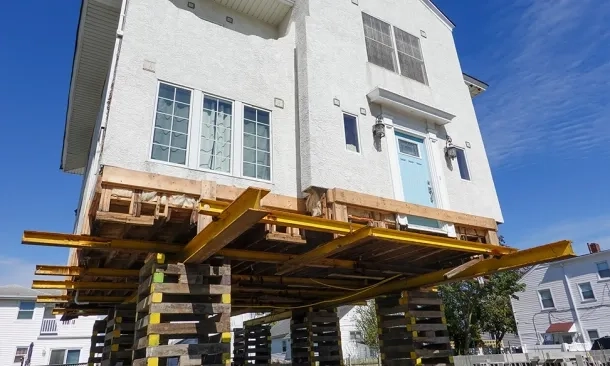 House temporarily elevated on wood blocks while work is done
