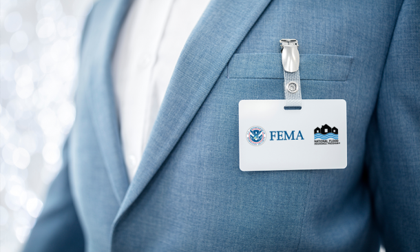 Close up of suited man's FEMA NFIP nametag