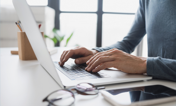 Person typing on laptop