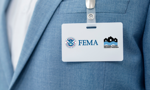 Close up of suited man's FEMA NFIP nametag