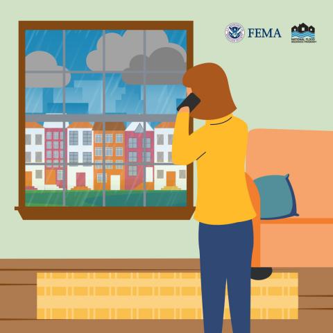person on the phone looking out the window