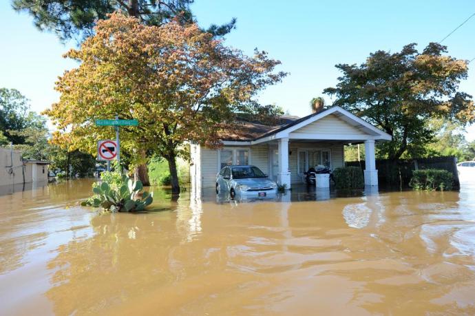 Image depicting a house surrounded by water