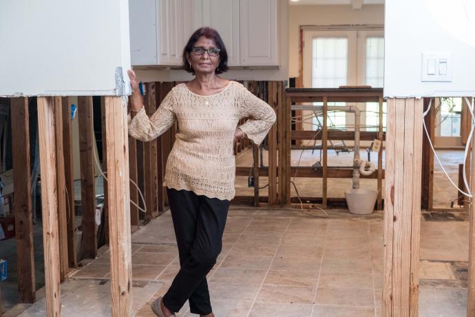Image depicting a woman in a home that is under construction