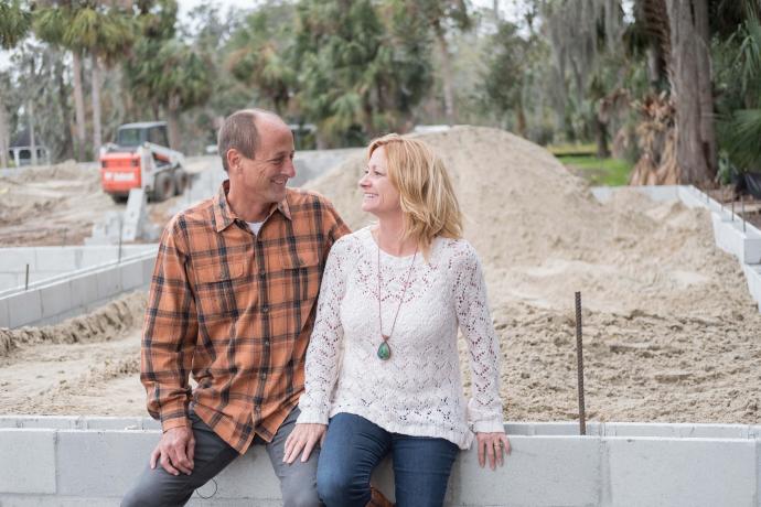 Image depicting a couple sitting in a construction site