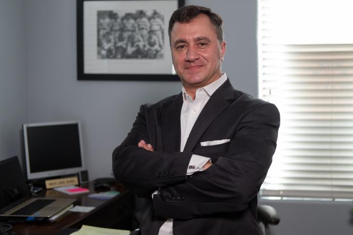 A picture of a man standing in an office.