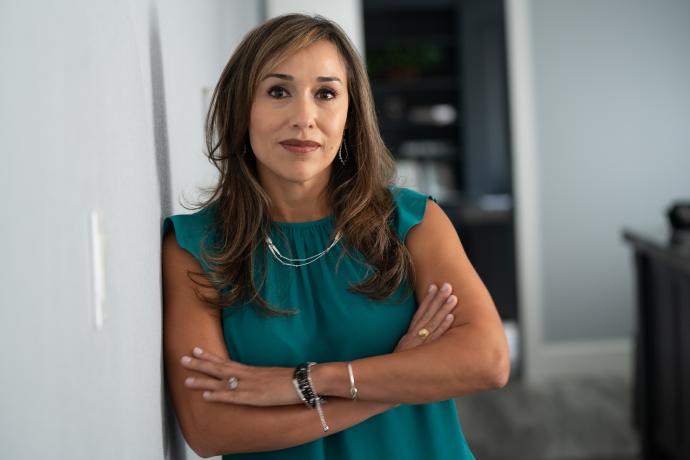 A picture of a woman standing next to a wall.