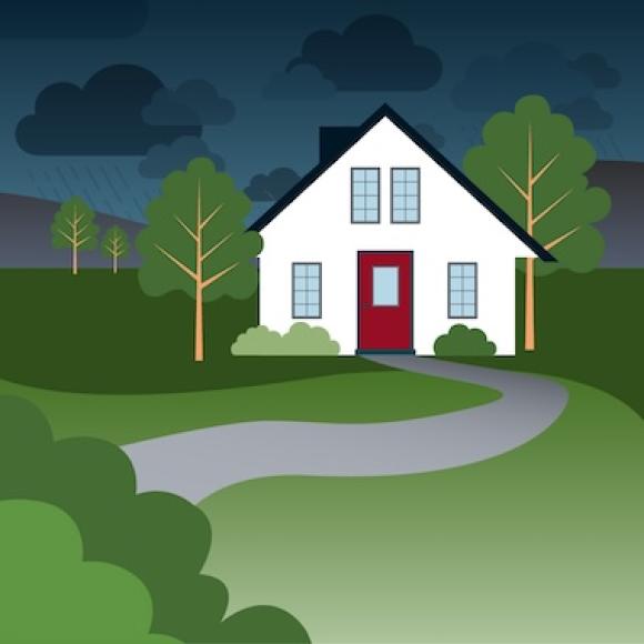 Rainstorm over country house surrounded by forest