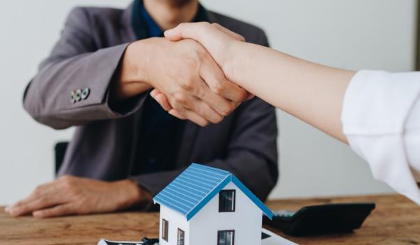 People shaking hands over a home agreement
