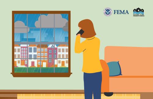 person talking on a cell phone looking outside their window